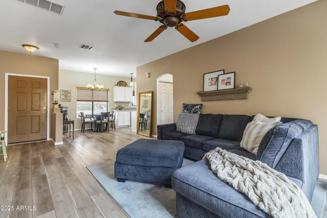a living room with furniture and a wooden floor