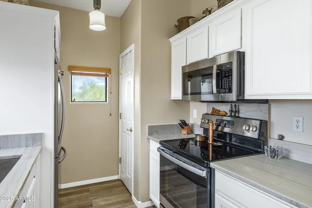 a kitchen with stainless steel appliances granite countertop a stove and a microwave