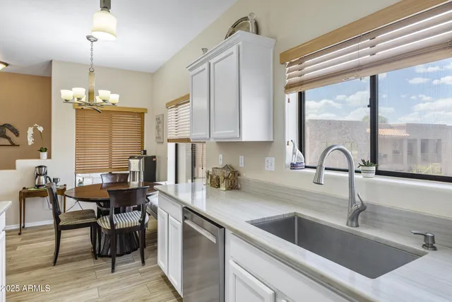 a kitchen with a sink cabinets and dining table