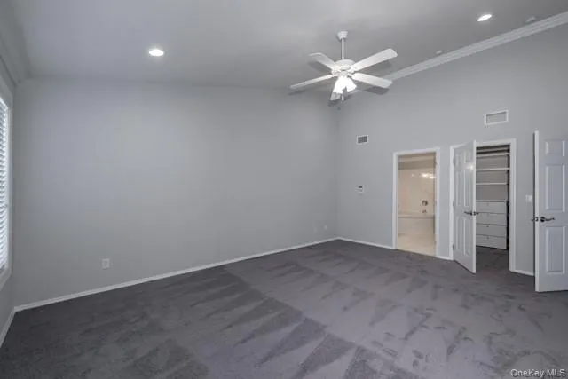 an empty room with a ceiling fan and a window