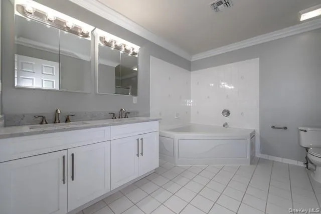 a spacious bathroom with a granite countertop sink mirror and a bathtub