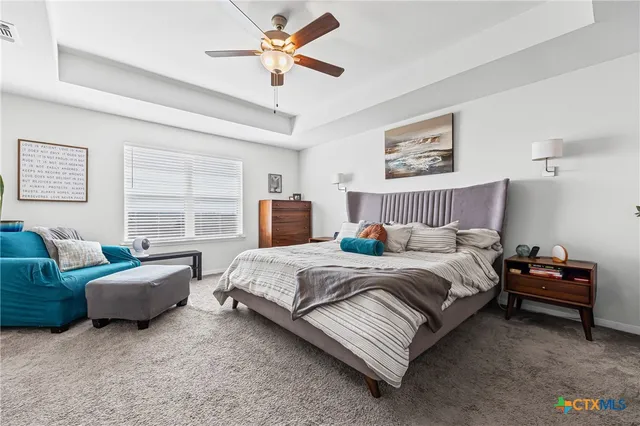 a bedroom with bed couch and window