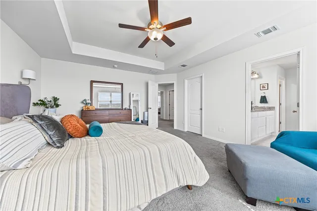 a bedroom with a bed a bed and a chandelier