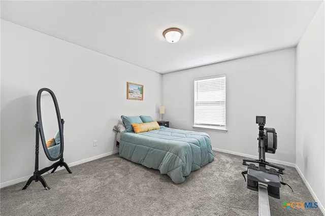 a bedroom with a bed a desk and chair