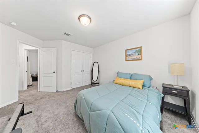 a bedroom with a bed and a lamp