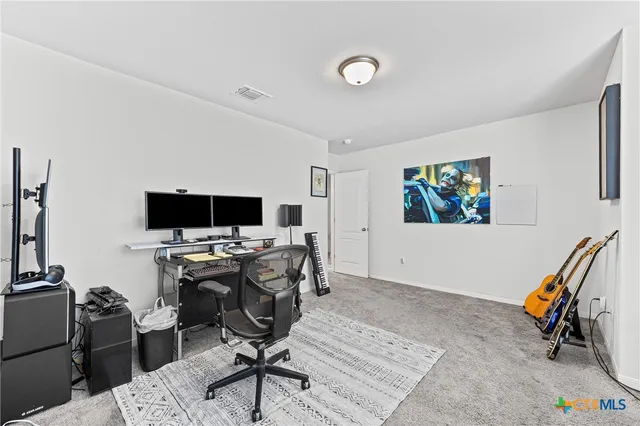 a view of a livingroom with workspace and a window