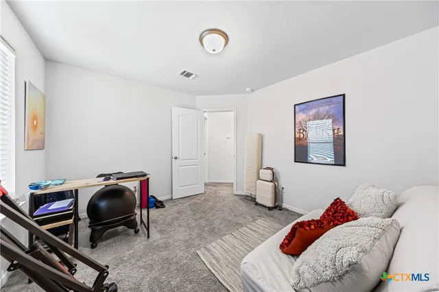 a bedroom with furniture and a window