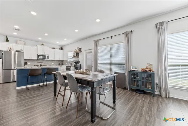 a view of a dining room with furniture window and wooden floor