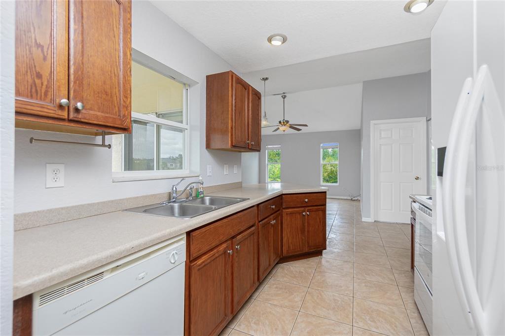 11708 Willmington Boulevard Port Charlotte, FL 33981 - Photo 11 of 41 a kitchen with a sink stove and cabinets