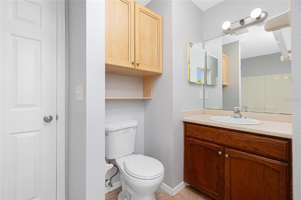 11708 Willmington Boulevard Port Charlotte, FL 33981 - Photo 19 of 41 a bathroom with a toilet a sink and mirror