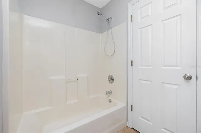 a bathroom with a shower and a bath tub