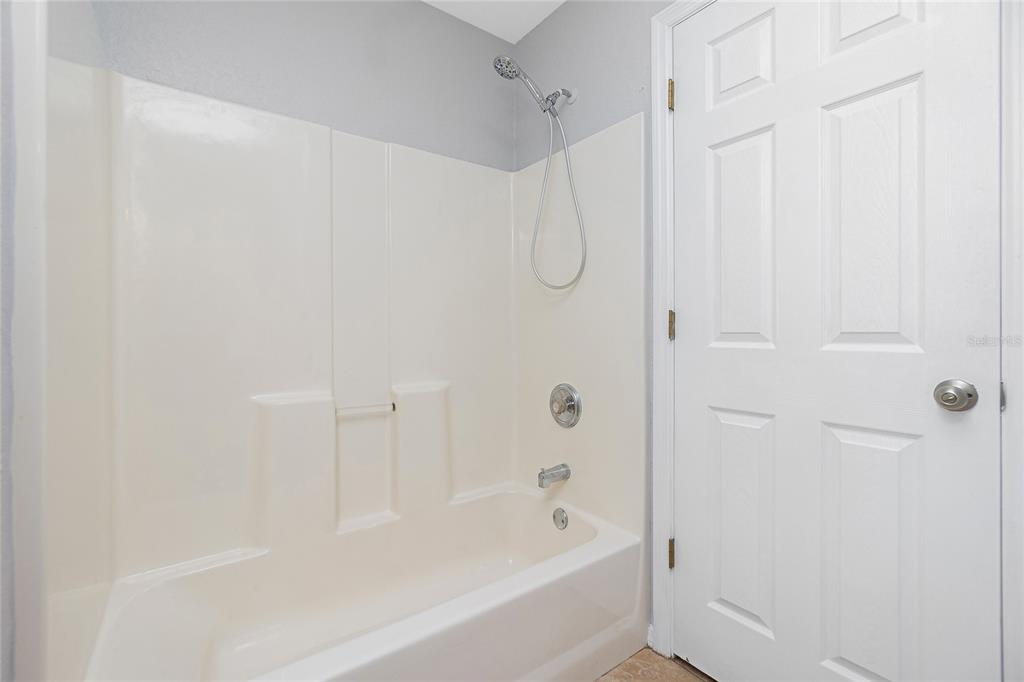 11708 Willmington Boulevard Port Charlotte, FL 33981 - Photo 20 of 41 a bathroom with a shower and a bath tub