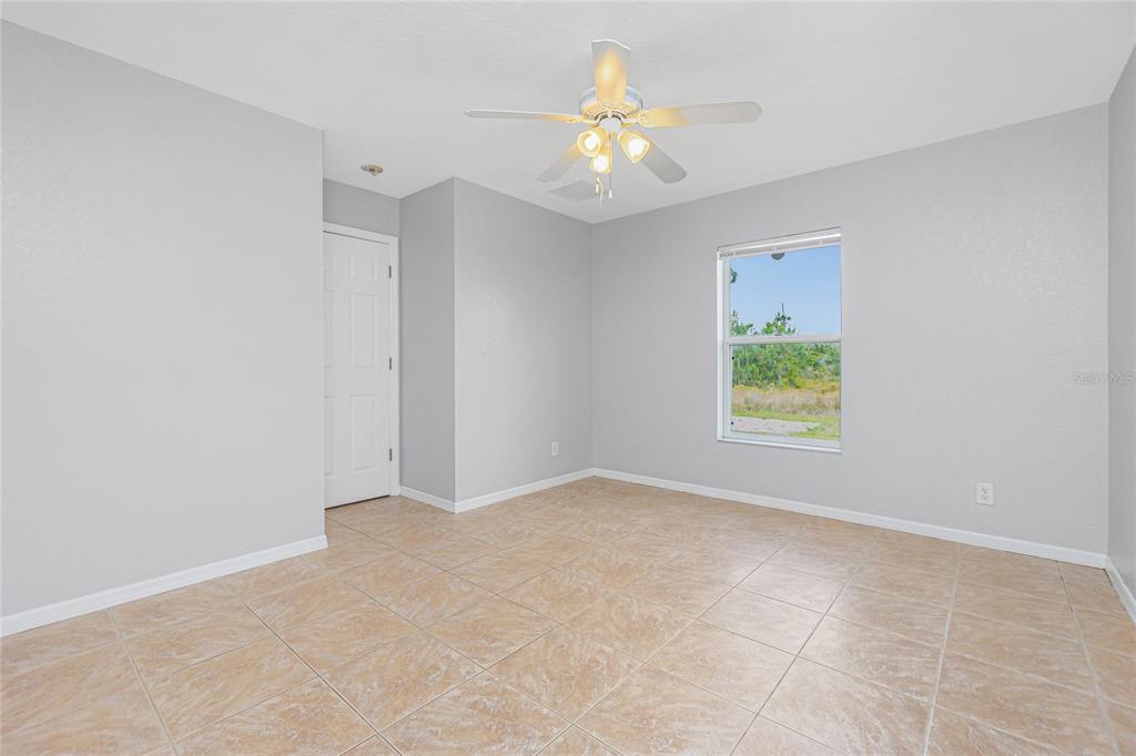 11708 Willmington Boulevard Port Charlotte, FL 33981 - Photo 22 of 41 an empty room with a window