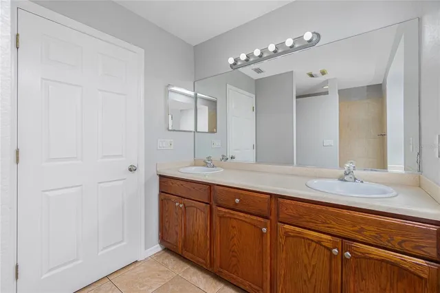 a bathroom with double vanity sinks and a mirror
