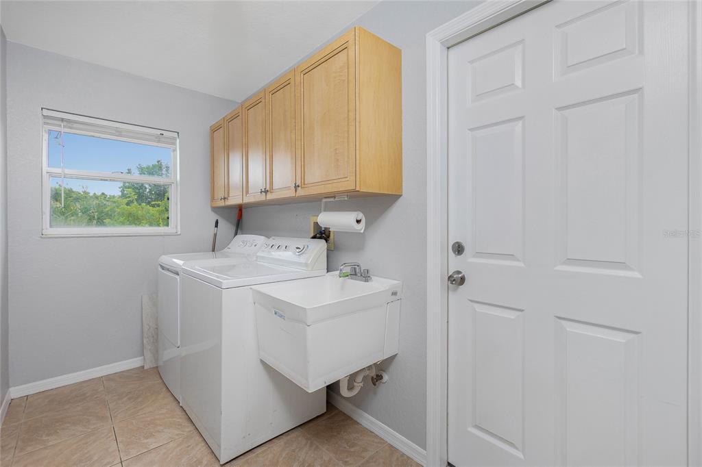 11708 Willmington Boulevard Port Charlotte, FL 33981 - Photo 35 of 41 a kitchen with a sink cabinets and a window