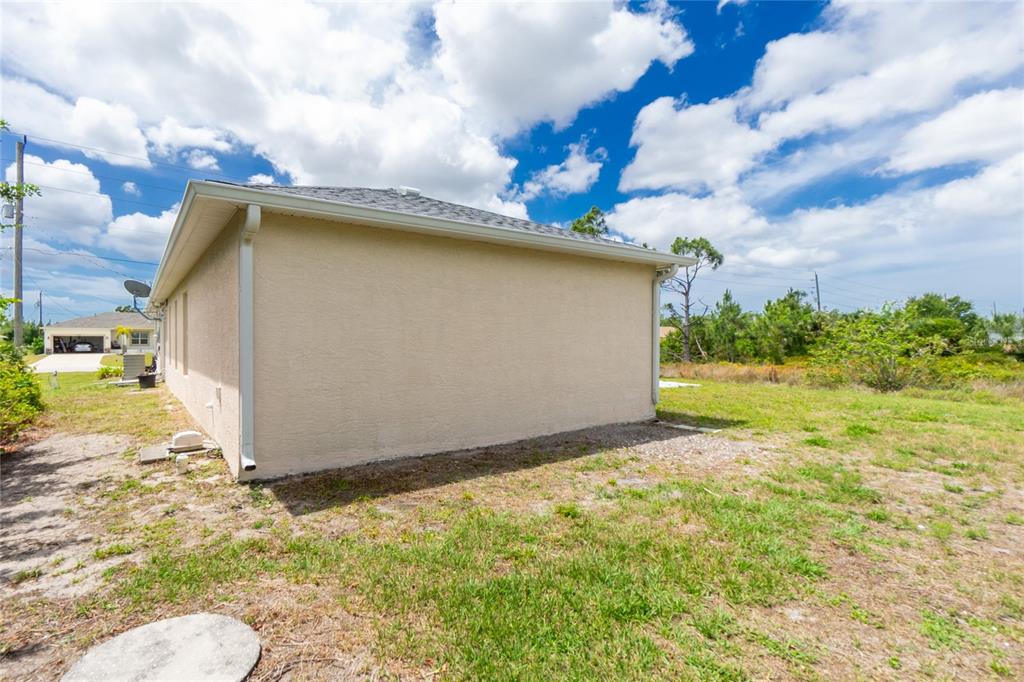 11708 Willmington Boulevard Port Charlotte, FL 33981 - Photo 37 of 41 a backyard of a house with lots of green space
