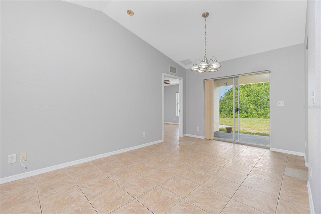 11708 Willmington Boulevard Port Charlotte, FL 33981 - Photo 8 of 41 a view of a room with window chandelier and carpet