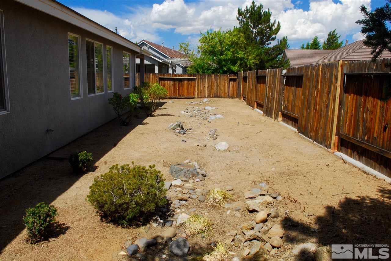 1437 Wild Wolf Way Reno, NV 89521 - Photo 18 of 20 a view of backyard with small cabin and wooden fence