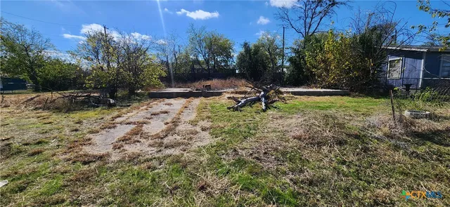 a view of swimming pool with a yard and green space