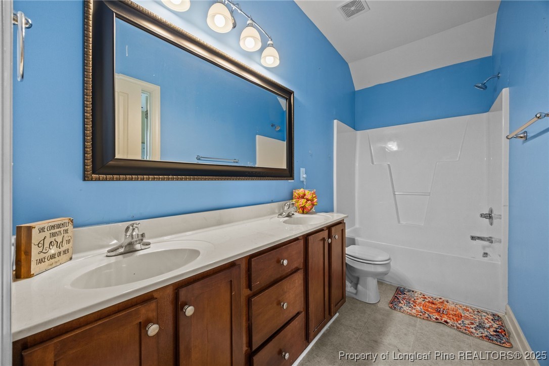 10 Braxton Court Erwin, NC 28339 - Photo 23 of 28 a bathroom with a sink a toilet and a mirror