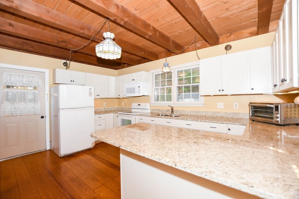 58 Alley Road Rochester, MA 02770 - Photo 16 of 29 a view of a kitchen with wooden floor and a refrigerator