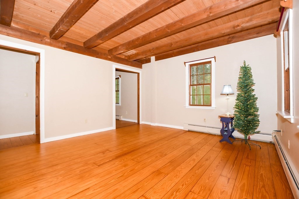 58 Alley Road Rochester, MA 02770 - Photo 17 of 29 a view of an empty room with wooden floor and a window
