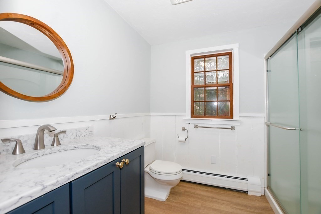 58 Alley Road Rochester, MA 02770 - Photo 29 of 29 a bathroom with a granite countertop sink a toilet and a mirror
