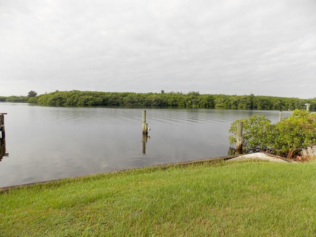 100 Southwest Hideaway Place Stuart, FL 34994 - Photo 1 of 23 a view of a lake with houses in the back