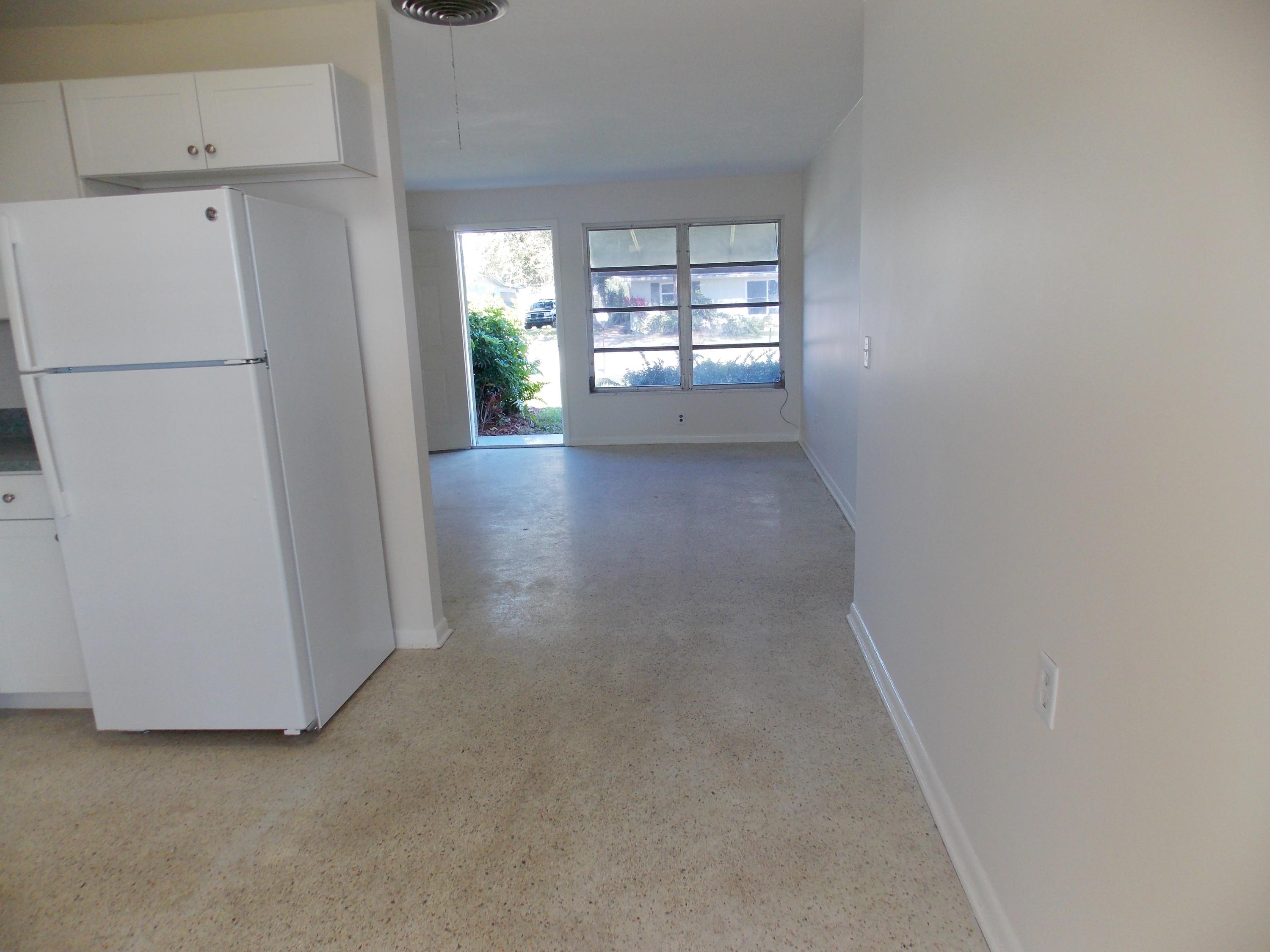 100 Southwest Hideaway Place Stuart, FL 34994 - Photo 12 of 23 a view of a refrigerator in kitchen and a window