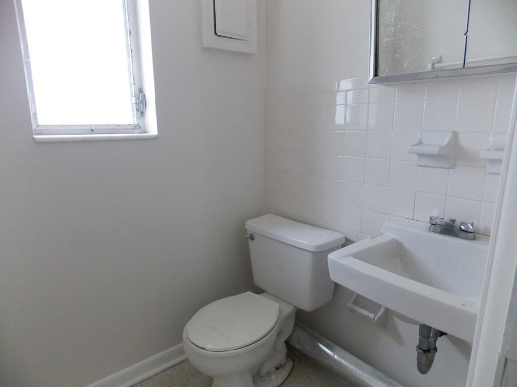 100 Southwest Hideaway Place Stuart, FL 34994 - Photo 16 of 23 a white toilet sitting next to a bathroom sink