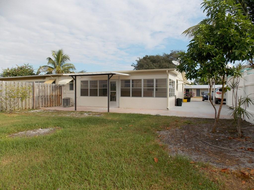 100 Southwest Hideaway Place Stuart, FL 34994 - Photo 21 of 23 a view of a house with backyard and a garden