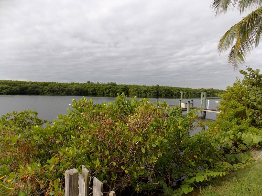 100 Southwest Hideaway Place Stuart, FL 34994 - Photo 3 of 23 a view of a lake with houses in background