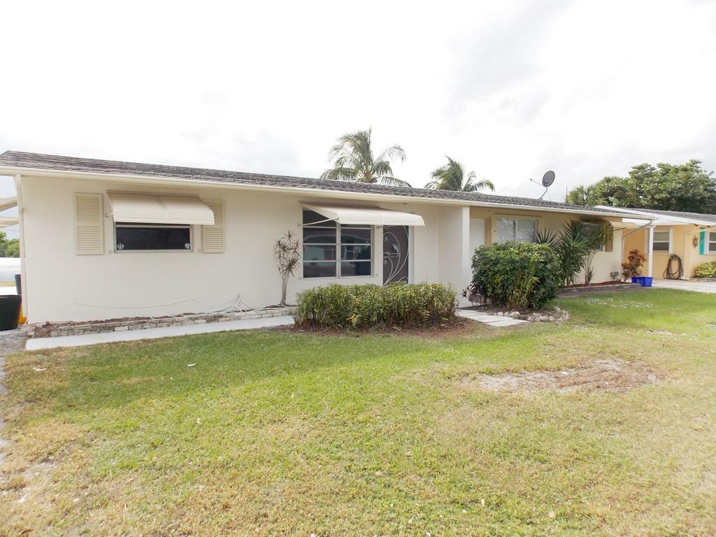 100 Southwest Hideaway Place Stuart, FL 34994 - Photo 4 of 23 a house view with a garden space