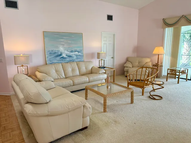 a living room with furniture and a wall painting