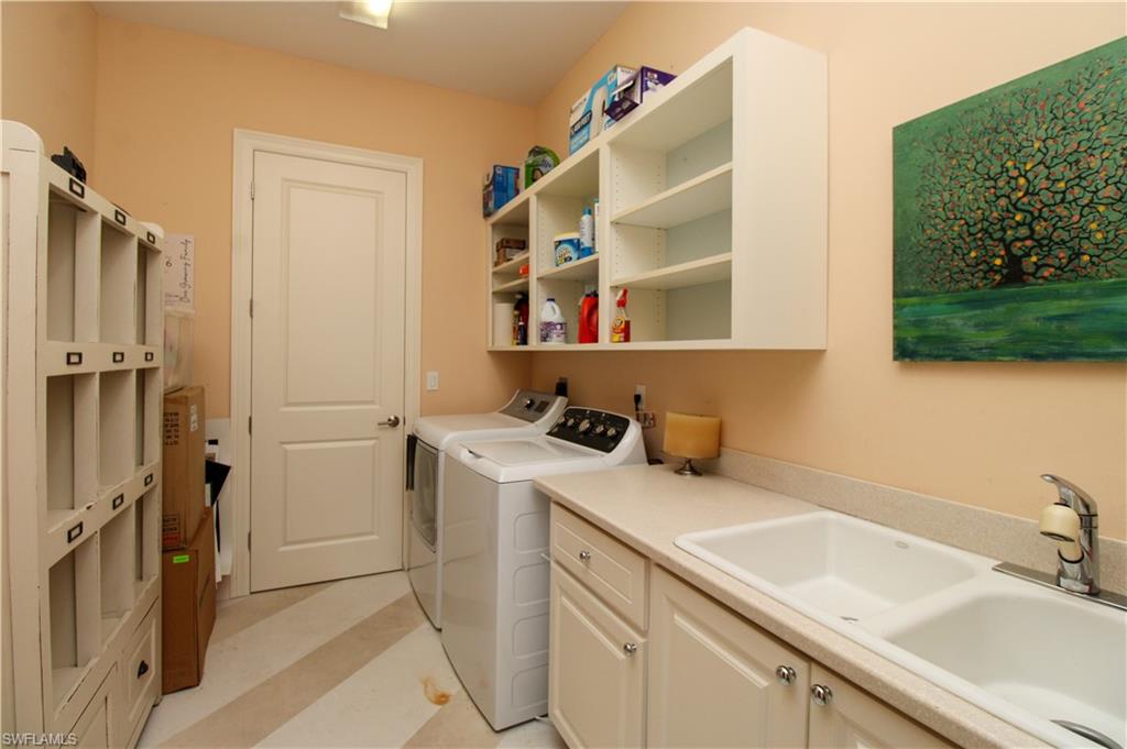 6184 Whitaker Road Naples, FL 34112 - Photo 20 of 50 a bathroom with a sink and a mirror