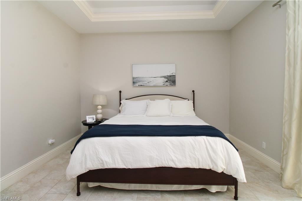 6184 Whitaker Road Naples, FL 34112 - Photo 21 of 50 a bedroom with a bed and a night stand