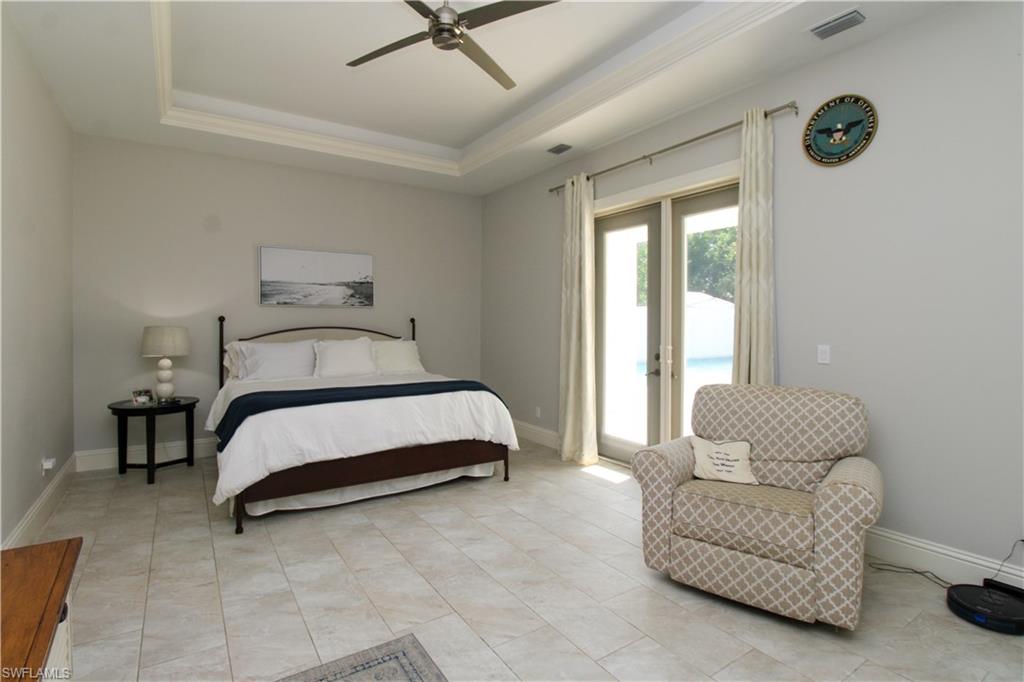 6184 Whitaker Road Naples, FL 34112 - Photo 22 of 50 a bedroom with a bed and a couch