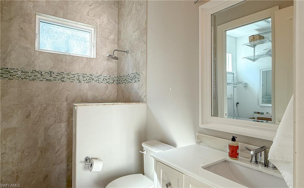 6184 Whitaker Road Naples, FL 34112 - Photo 41 of 50 a bathroom with a sink toilet and shower