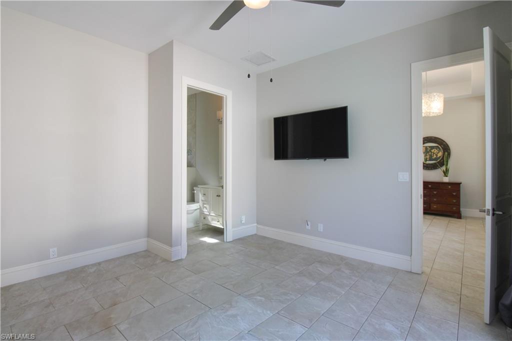 6184 Whitaker Road Naples, FL 34112 - Photo 45 of 50 wooden floor and flat screen tv