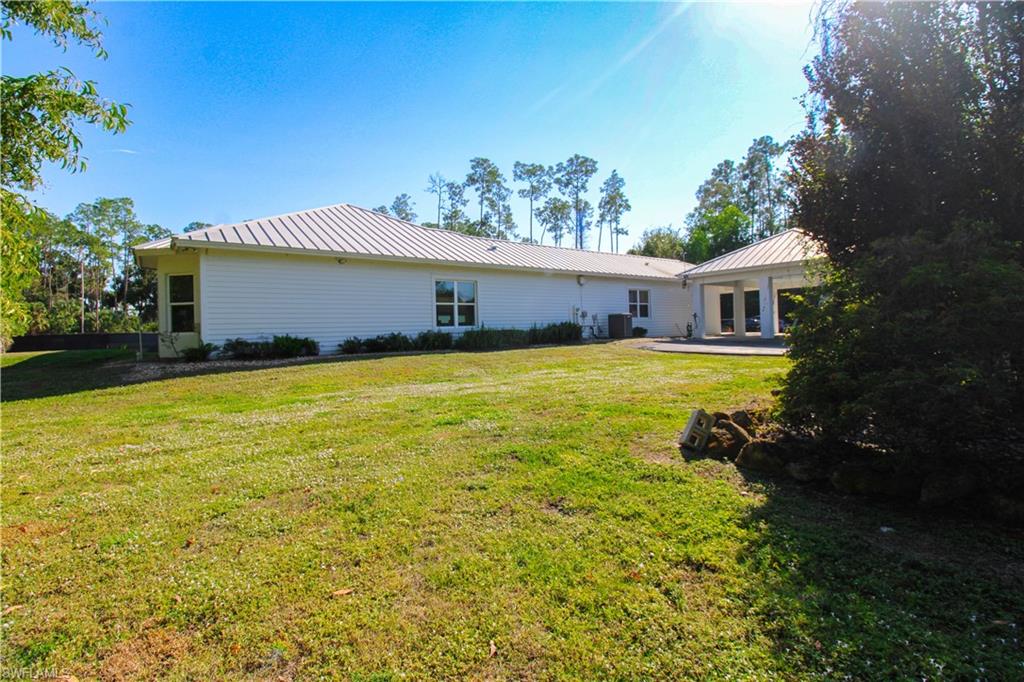6184 Whitaker Road Naples, FL 34112 - Photo 8 of 50 a view of a house with a yard and swimming pool