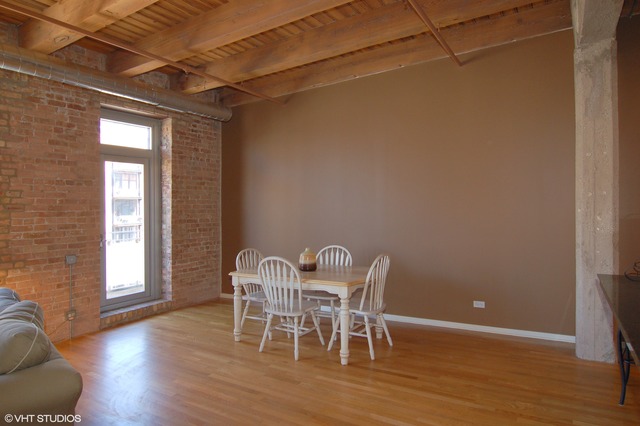 333 South Desplaines Street, Unit 605 Chicago, IL 60661 - Photo 4 of 8 a view of a dining room with furniture and wooden floor