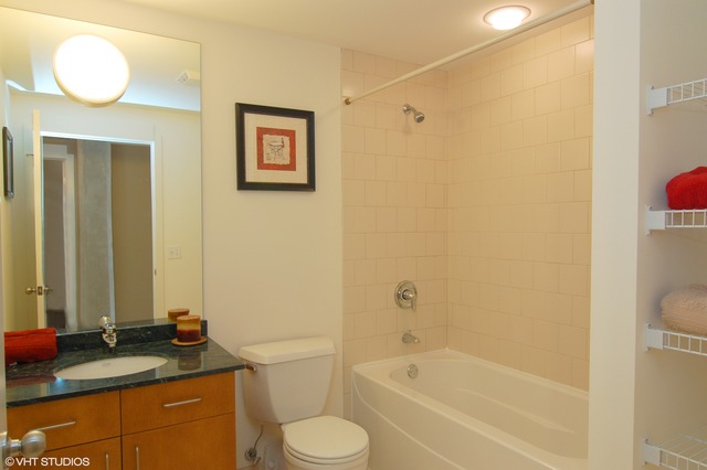 333 South Desplaines Street, Unit 605 Chicago, IL 60661 - Photo 7 of 8 a bathroom with a granite countertop sink toilet and shower