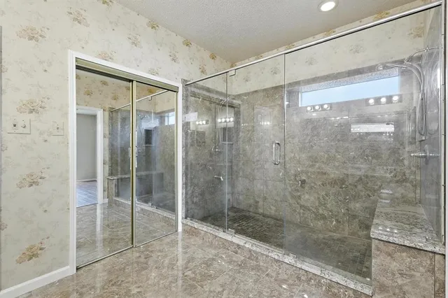 a bathroom with a glass shower door