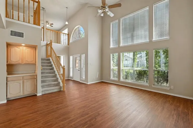 a view of a room with wooden floor staircase and windows