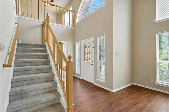 a view of an entryway with wooden floor and stairs