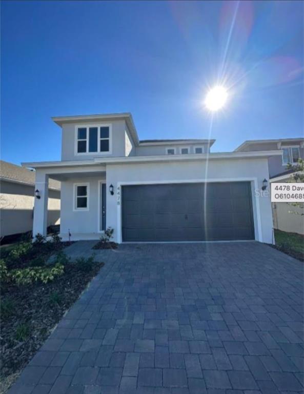 a view of a house with a yard and garage