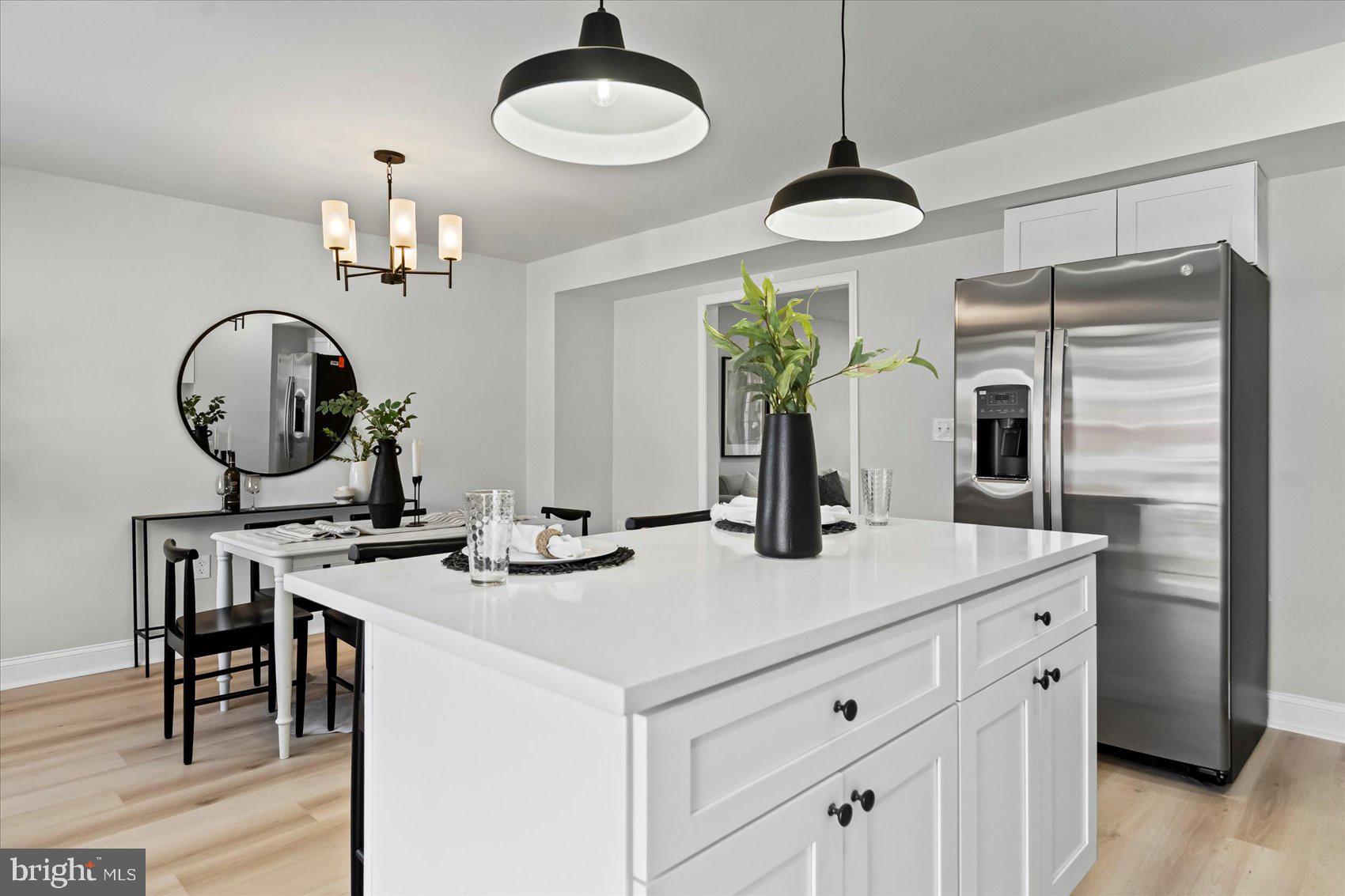 1812 Ingram Road Baltimore, MD 21239 - Photo 13 of 45 a kitchen with a table chairs and a chandelier