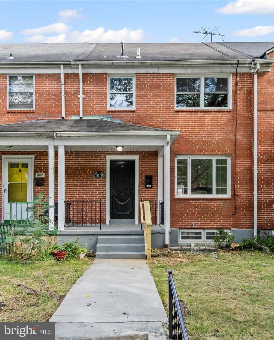 1812 Ingram Road Baltimore, MD 21239 - Photo 2 of 45 front view of a house with a yard