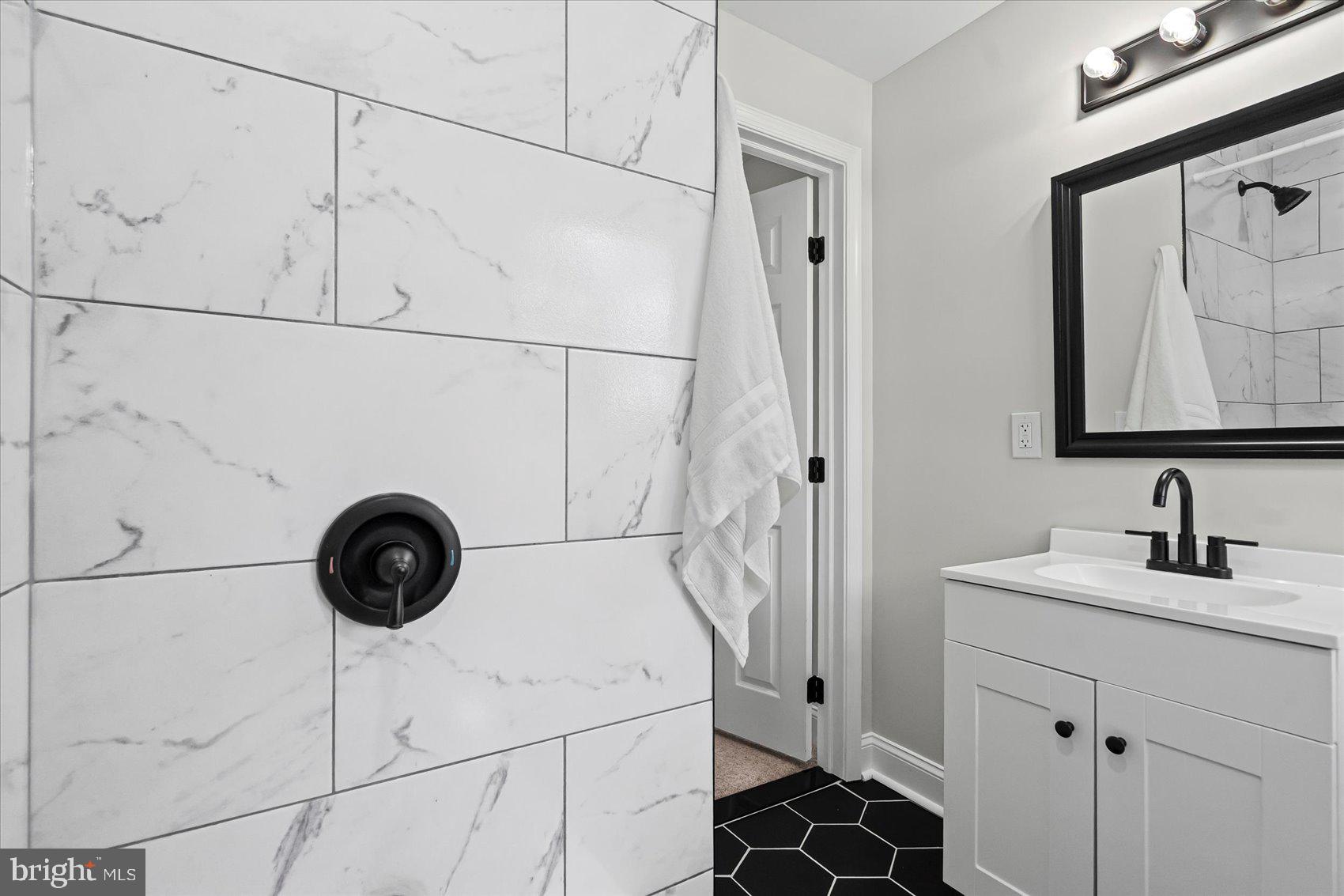 1812 Ingram Road Baltimore, MD 21239 - Photo 27 of 45 a bathroom with a sink and a mirror