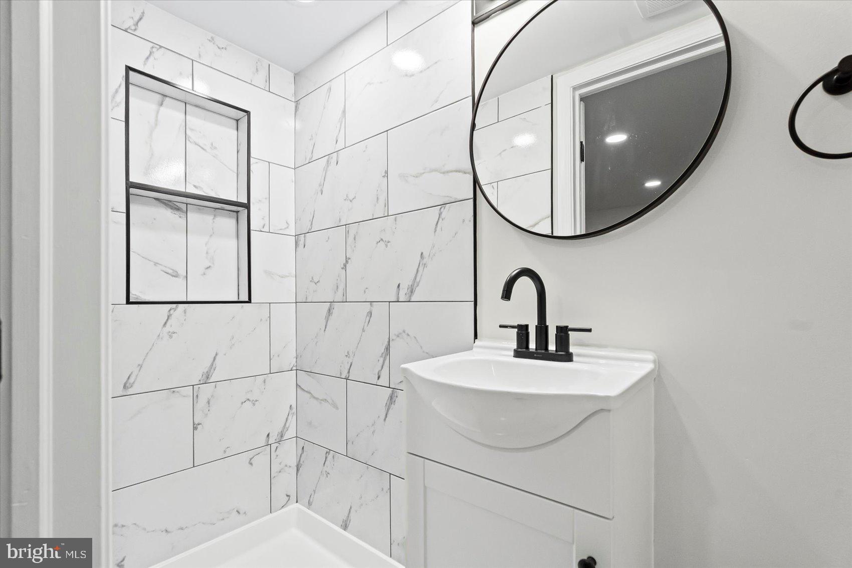 1812 Ingram Road Baltimore, MD 21239 - Photo 35 of 45 a bathroom with a sink and a mirror